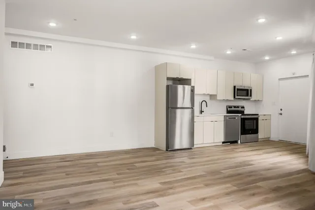a view of kitchen with refrigerator microwave and stove