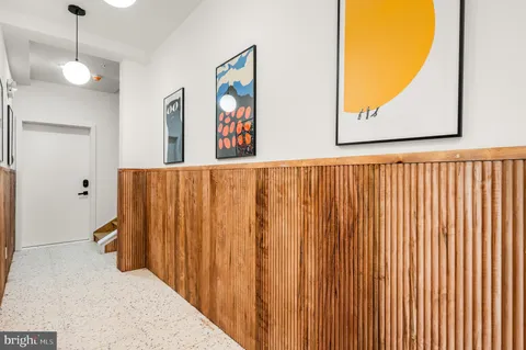 a view of a hallway with paintings on the wall