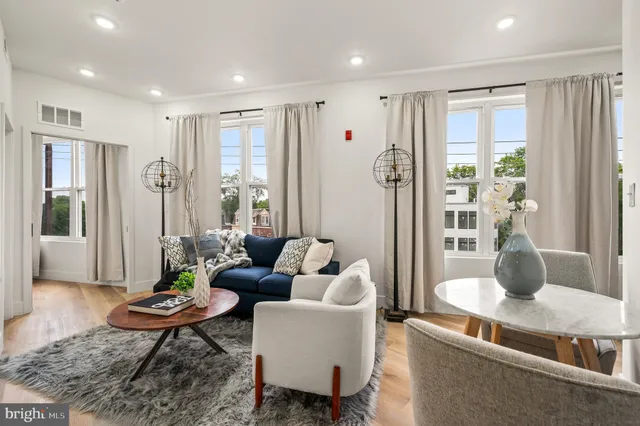 a living room with furniture and a large window