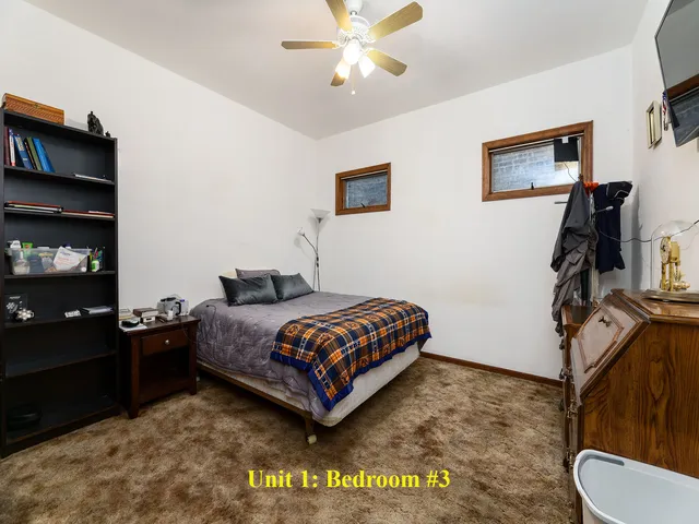 a kitchen with a refrigerator and a stove top oven