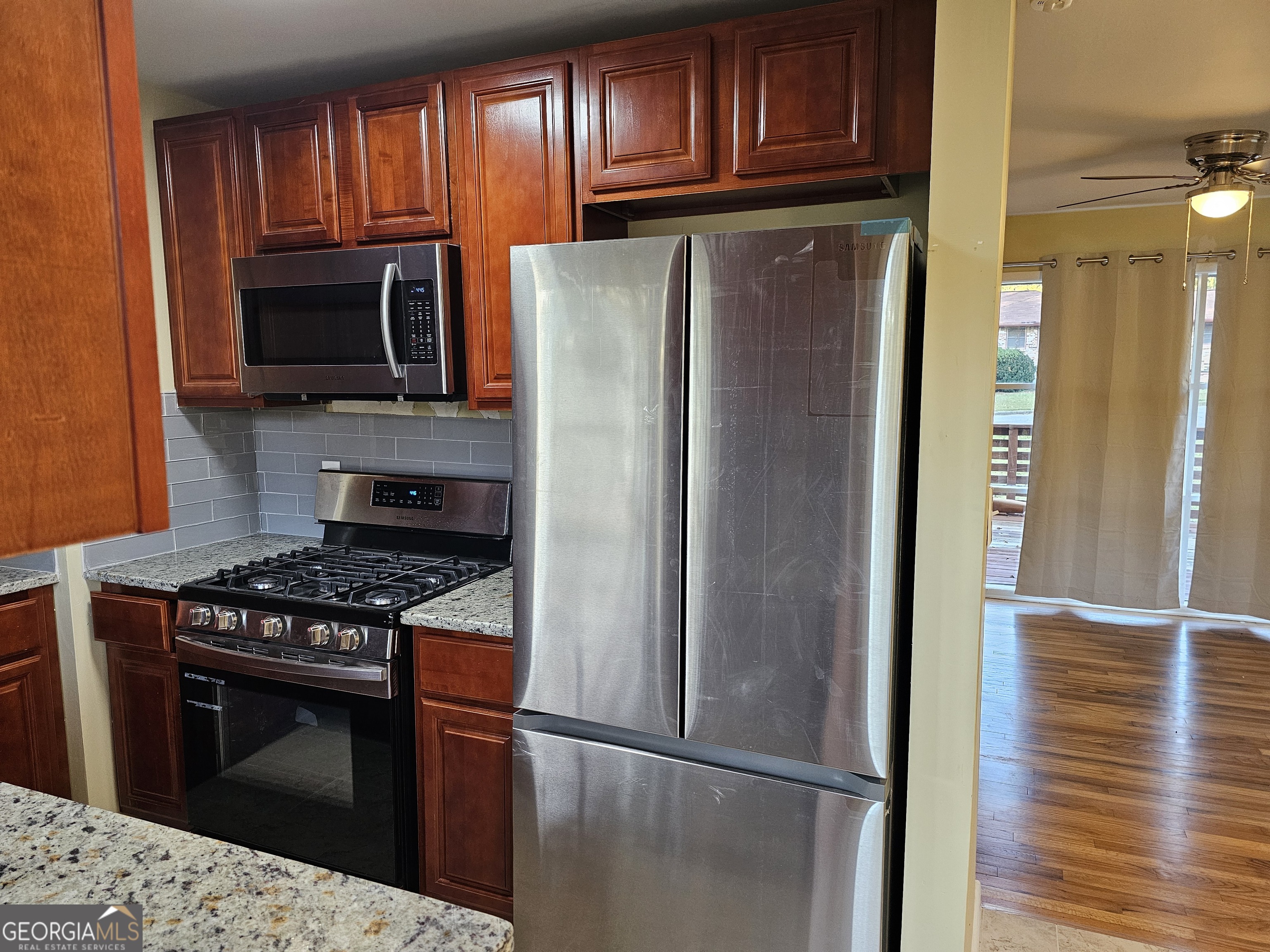 655 Shellnut Drive Forest Park, GA 30297 - Photo 13 of 31 a kitchen with stainless steel appliances granite countertop a refrigerator stove and microwave