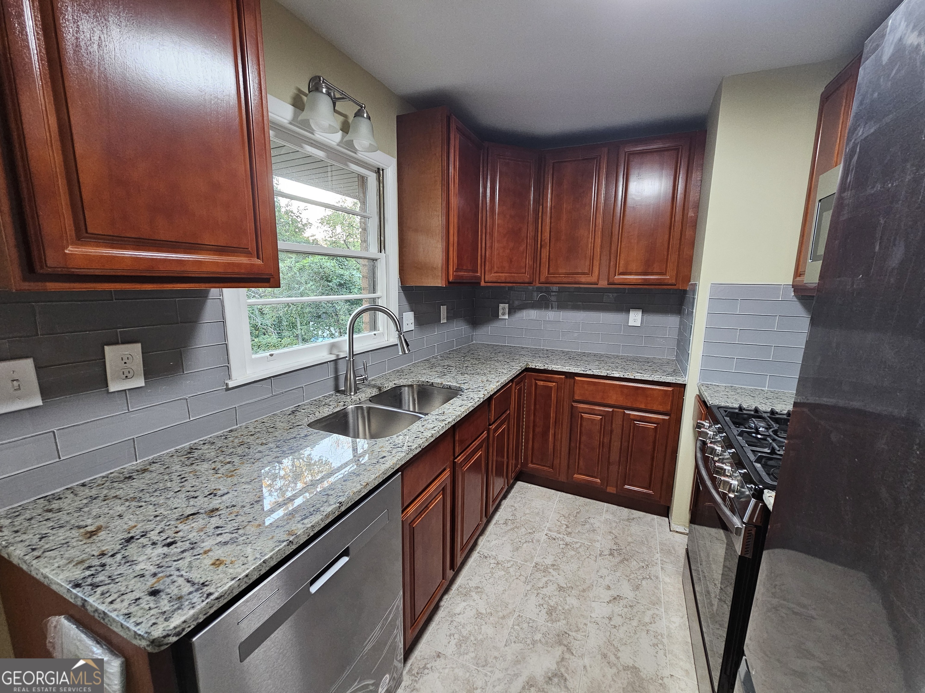 655 Shellnut Drive Forest Park, GA 30297 - Photo 15 of 31 a kitchen with granite countertop a sink a counter space and cabinets
