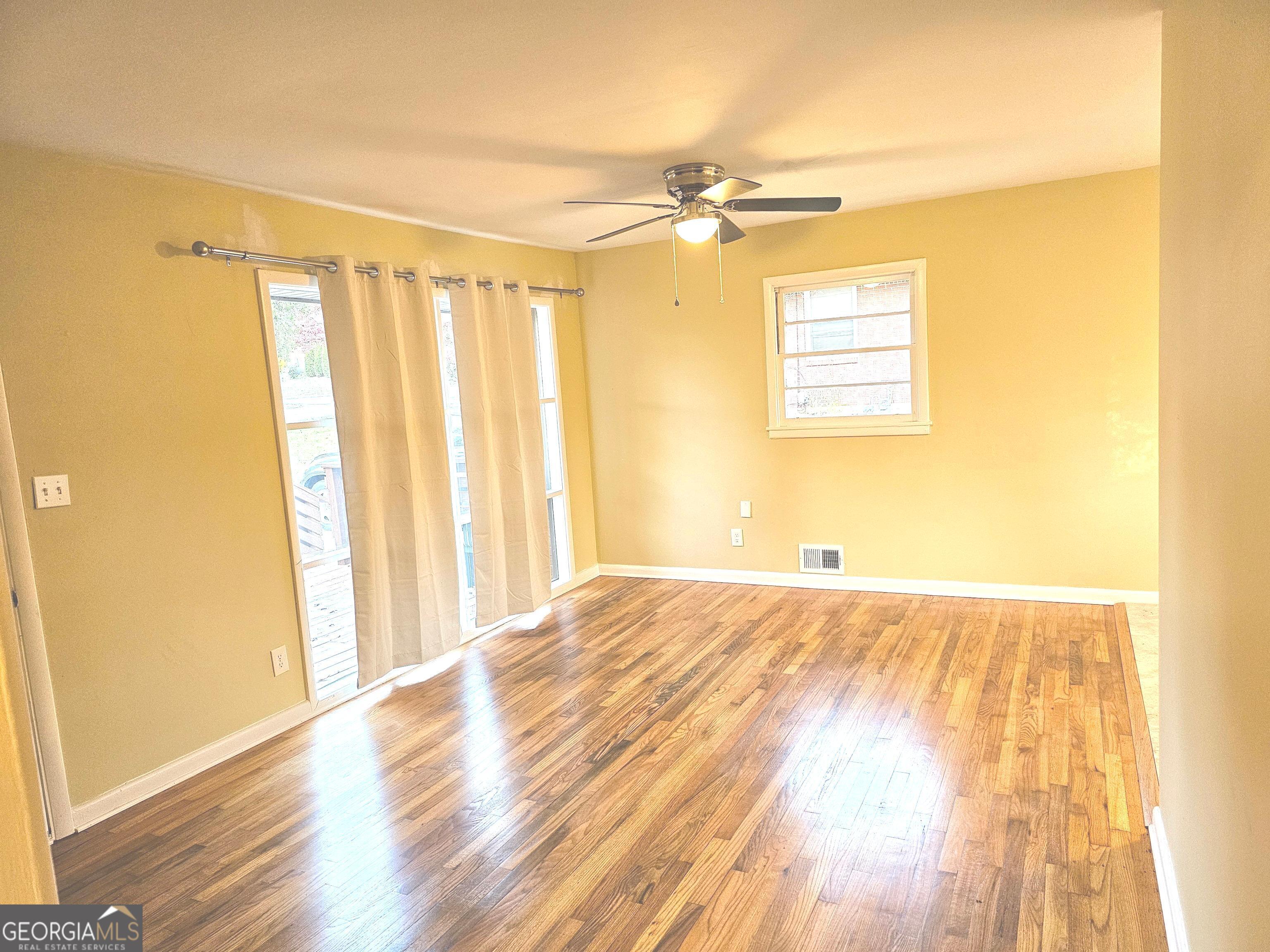 655 Shellnut Drive Forest Park, GA 30297 - Photo 17 of 31 a view of a room with wooden floor and a window