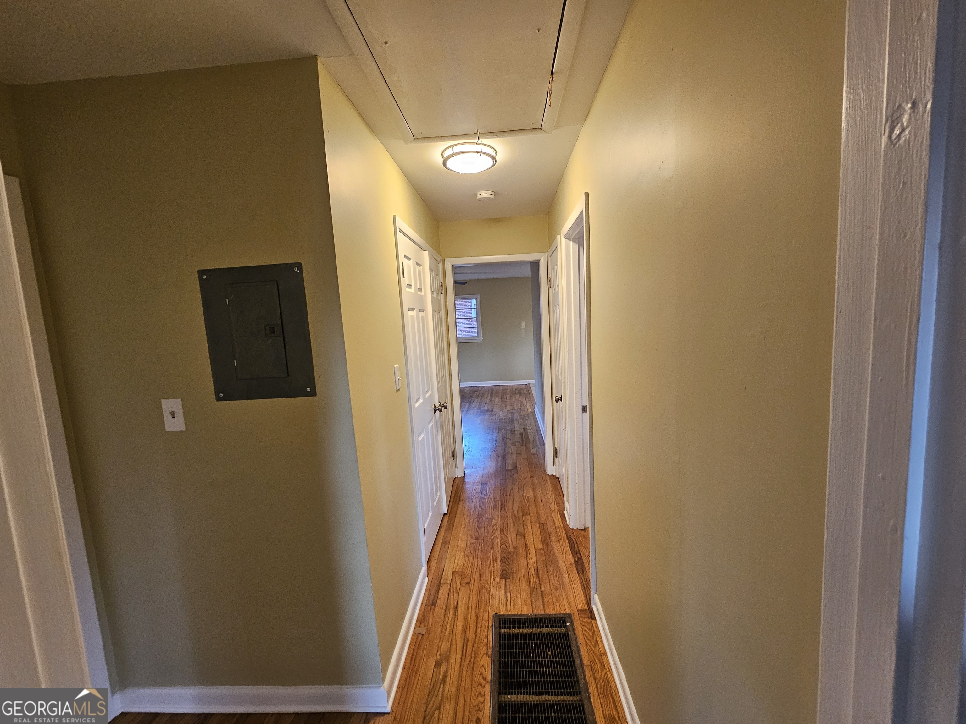 655 Shellnut Drive Forest Park, GA 30297 - Photo 19 of 31 a view of a hallway with wooden floor and staircase