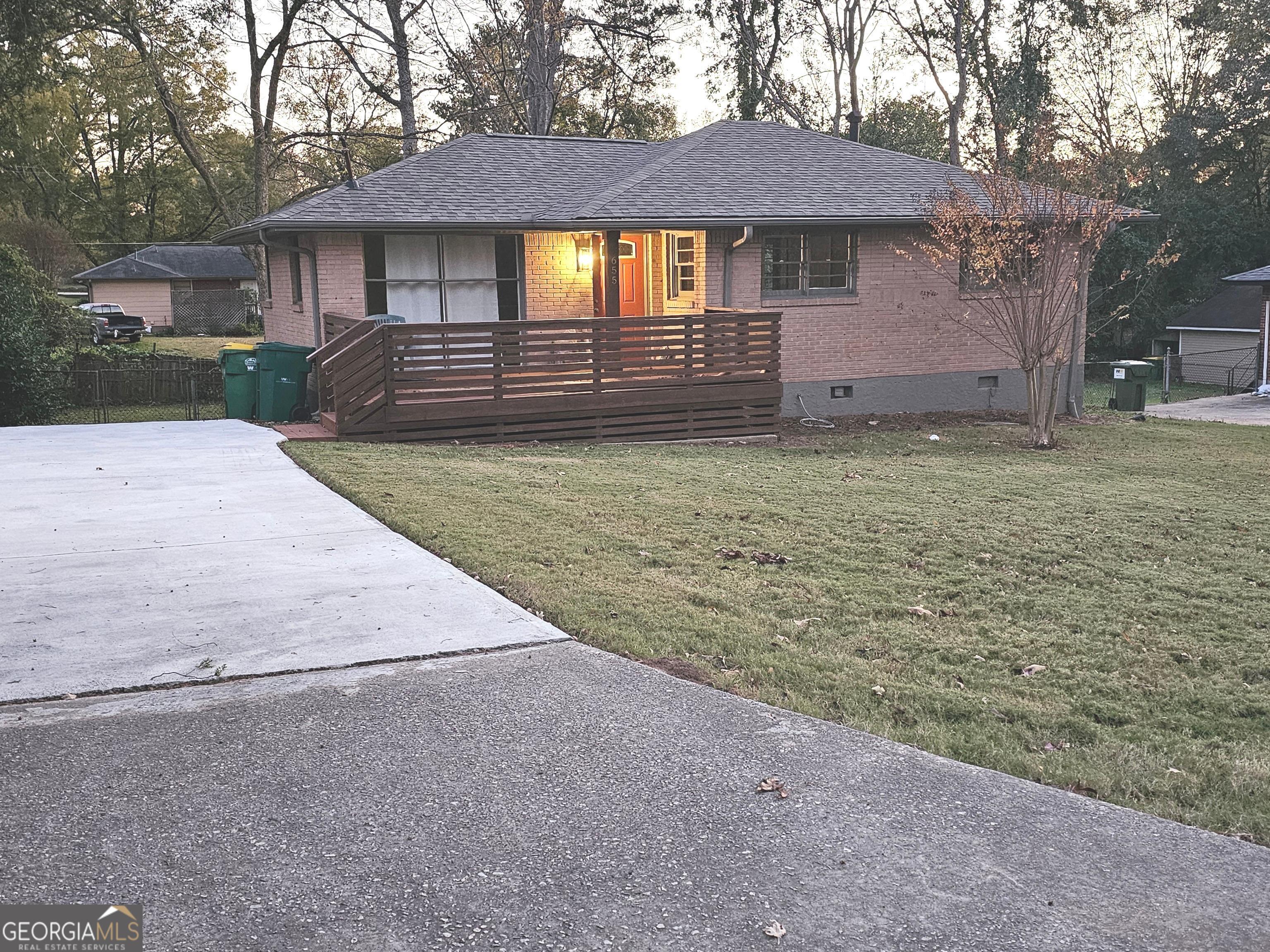 655 Shellnut Drive Forest Park, GA 30297 - Photo 2 of 31 a front view of a house with a yard and garage