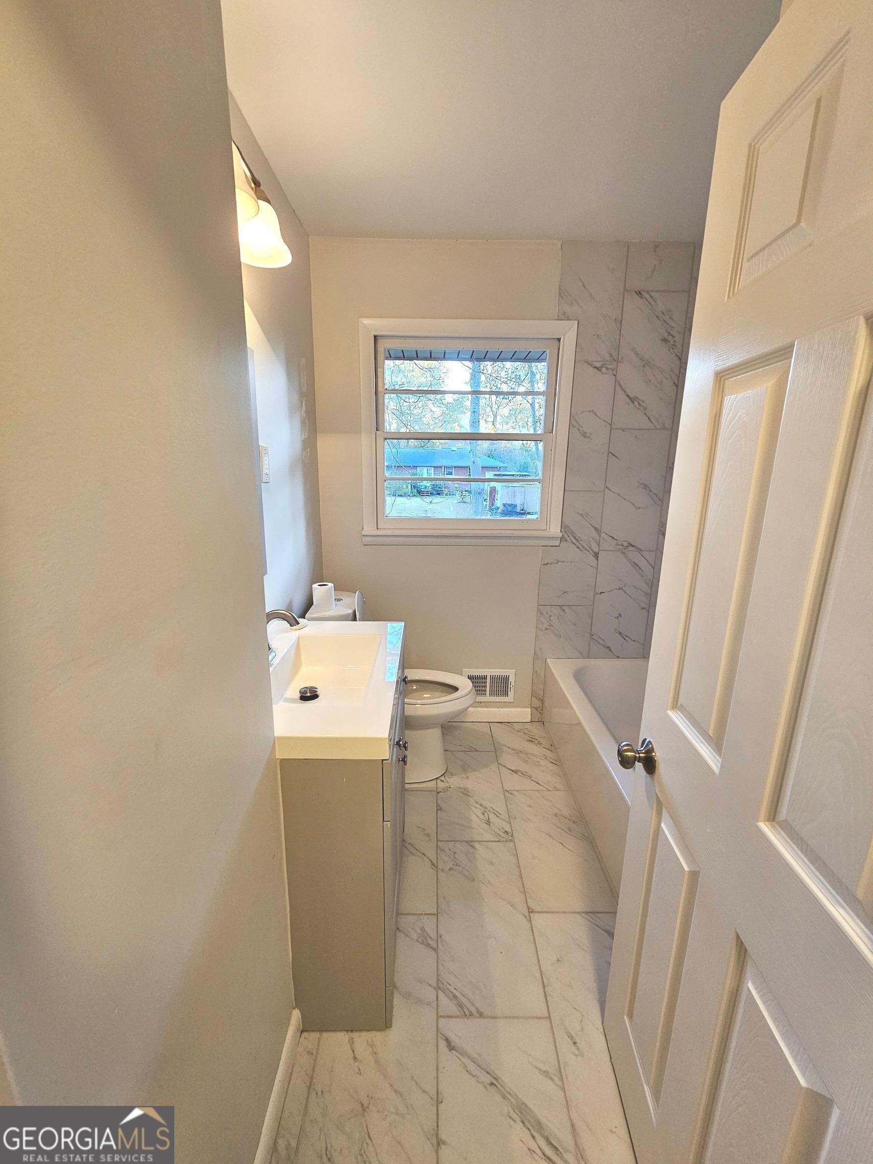 655 Shellnut Drive Forest Park, GA 30297 - Photo 21 of 31 a bathroom with a sink and a vanity