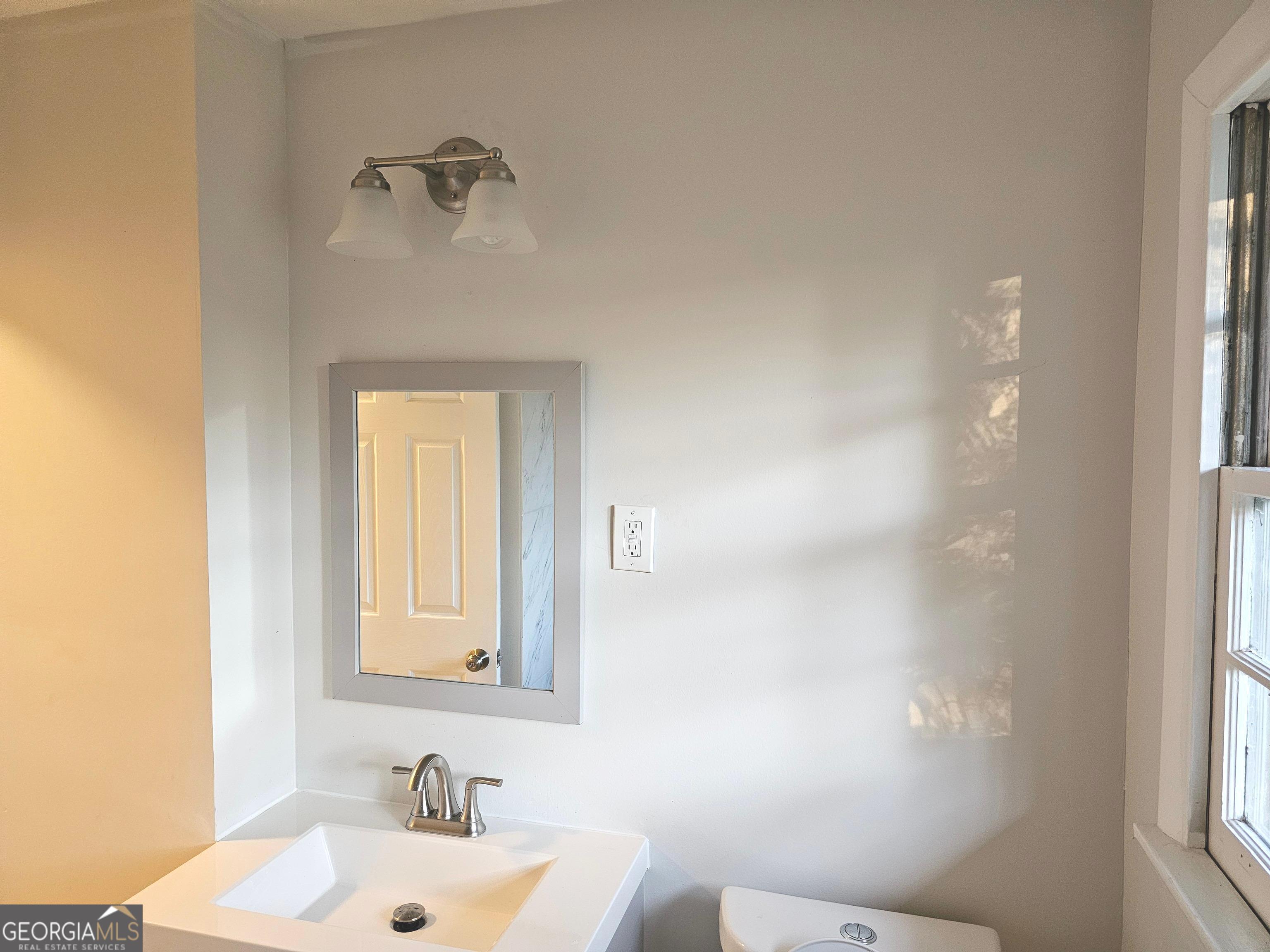 655 Shellnut Drive Forest Park, GA 30297 - Photo 22 of 31 a bathroom with a sink and a mirror