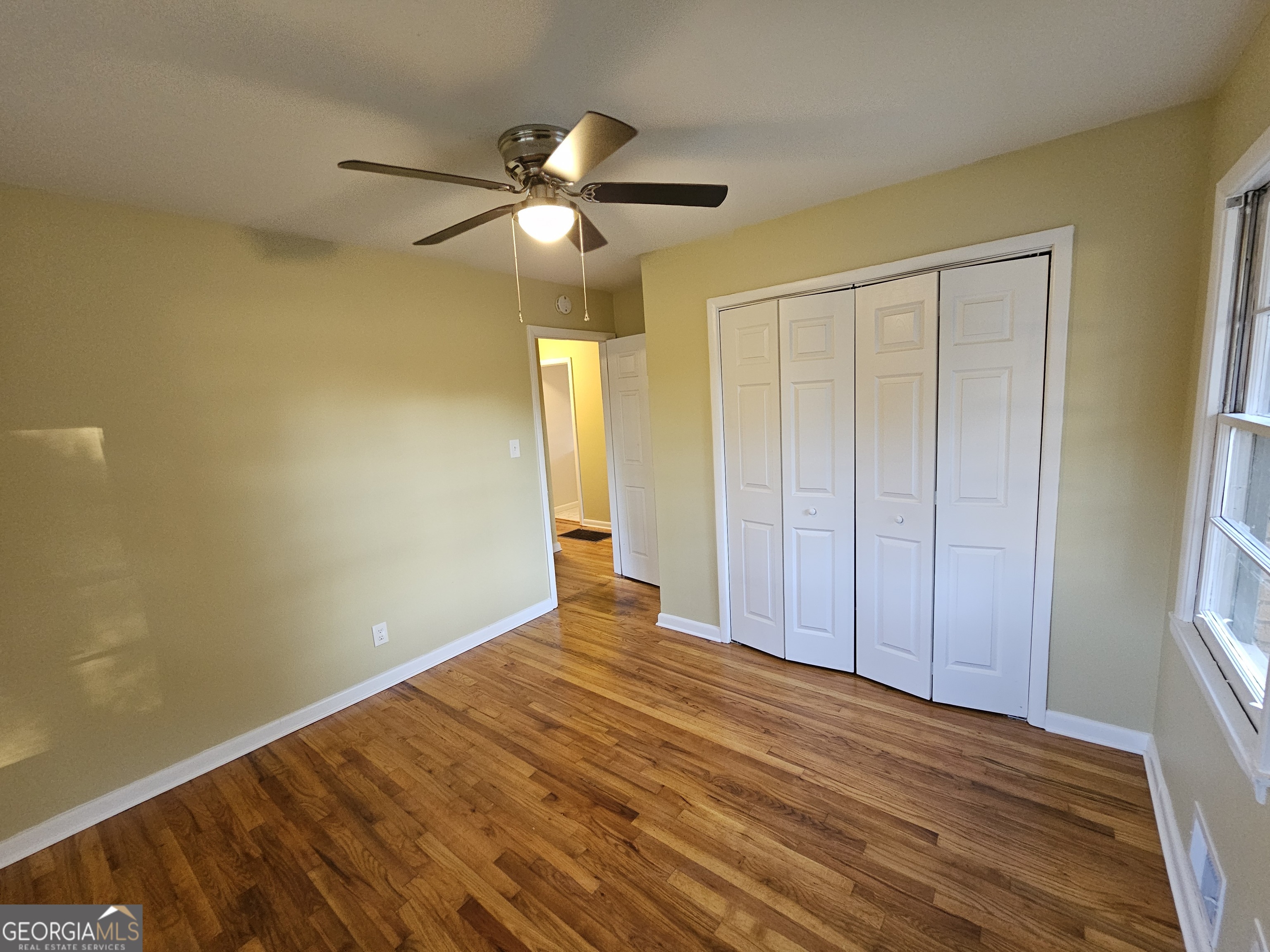 655 Shellnut Drive Forest Park, GA 30297 - Photo 25 of 31 a view of empty room with wooden floor and fan