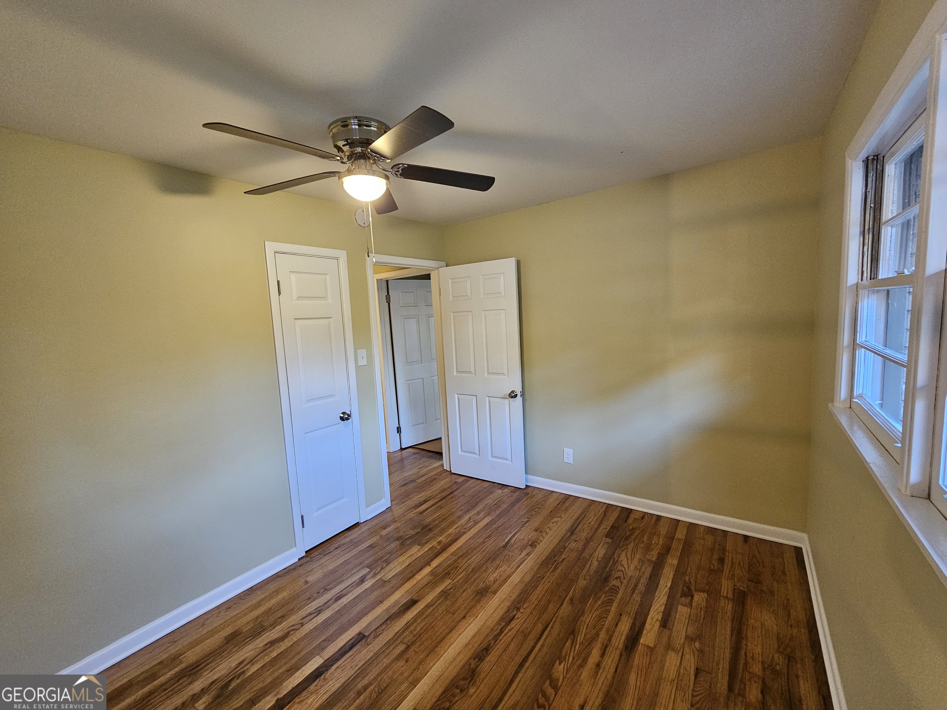 655 Shellnut Drive Forest Park, GA 30297 - Photo 26 of 31 a view of empty room with wooden floor and fan