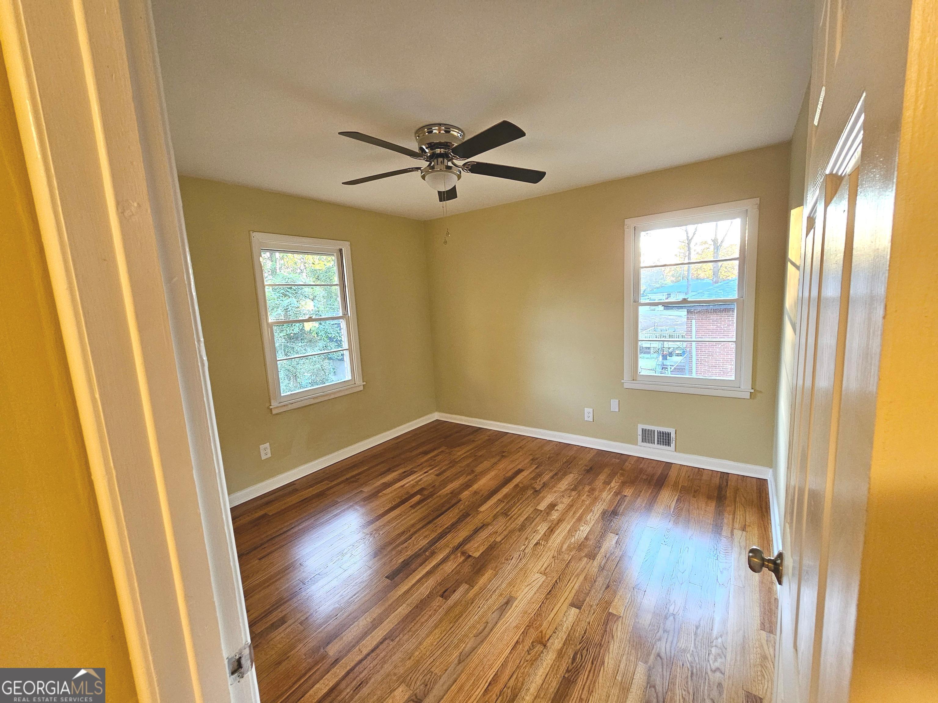 655 Shellnut Drive Forest Park, GA 30297 - Photo 27 of 31 a view of empty room with wooden floor and fan