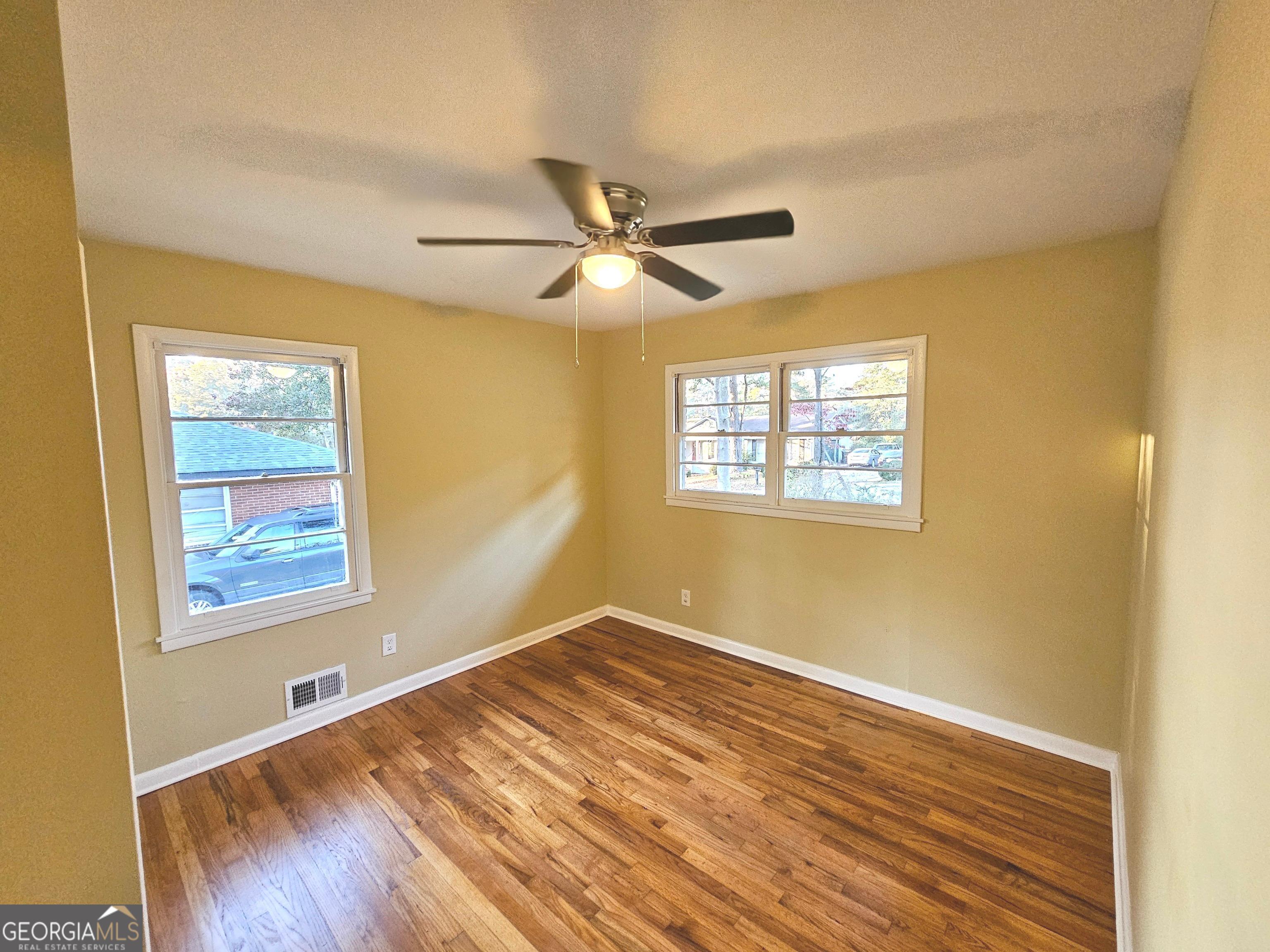 655 Shellnut Drive Forest Park, GA 30297 - Photo 28 of 31 a view of empty room with wooden floor and fan