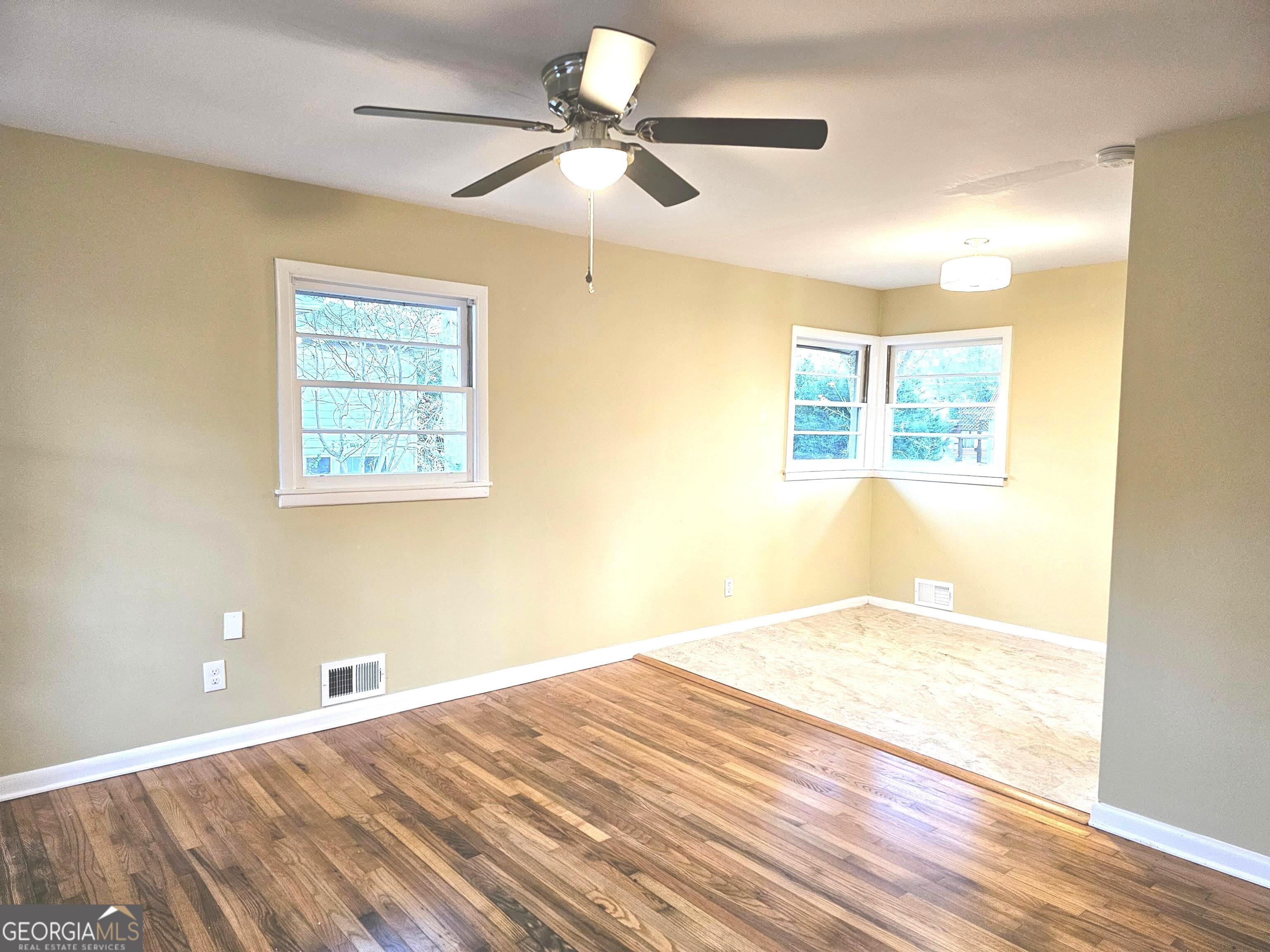 655 Shellnut Drive Forest Park, GA 30297 - Photo 5 of 31 a view of a big room with wooden floor and chandelier fan