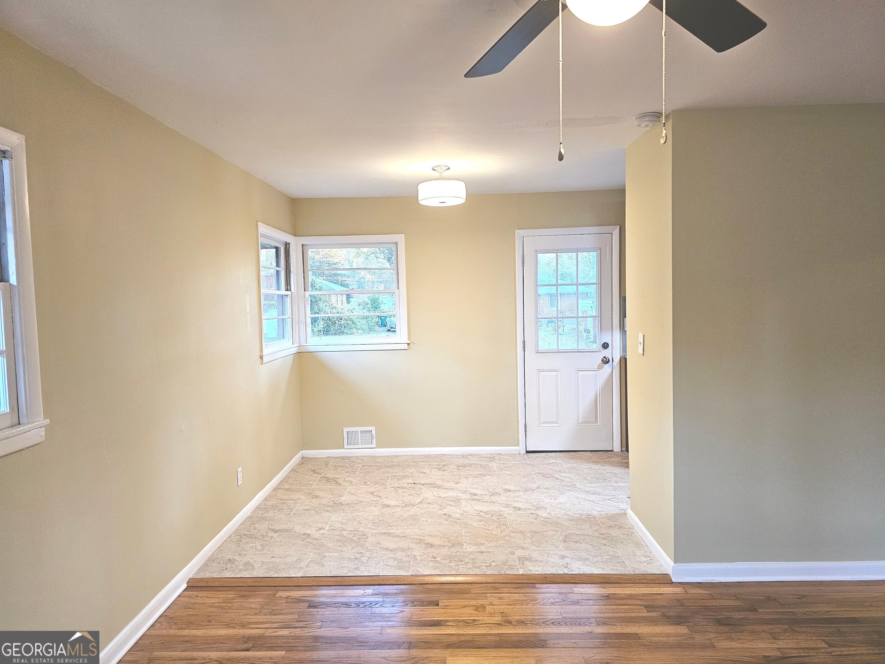 655 Shellnut Drive Forest Park, GA 30297 - Photo 7 of 31 a view of an empty room with wooden floor and a window