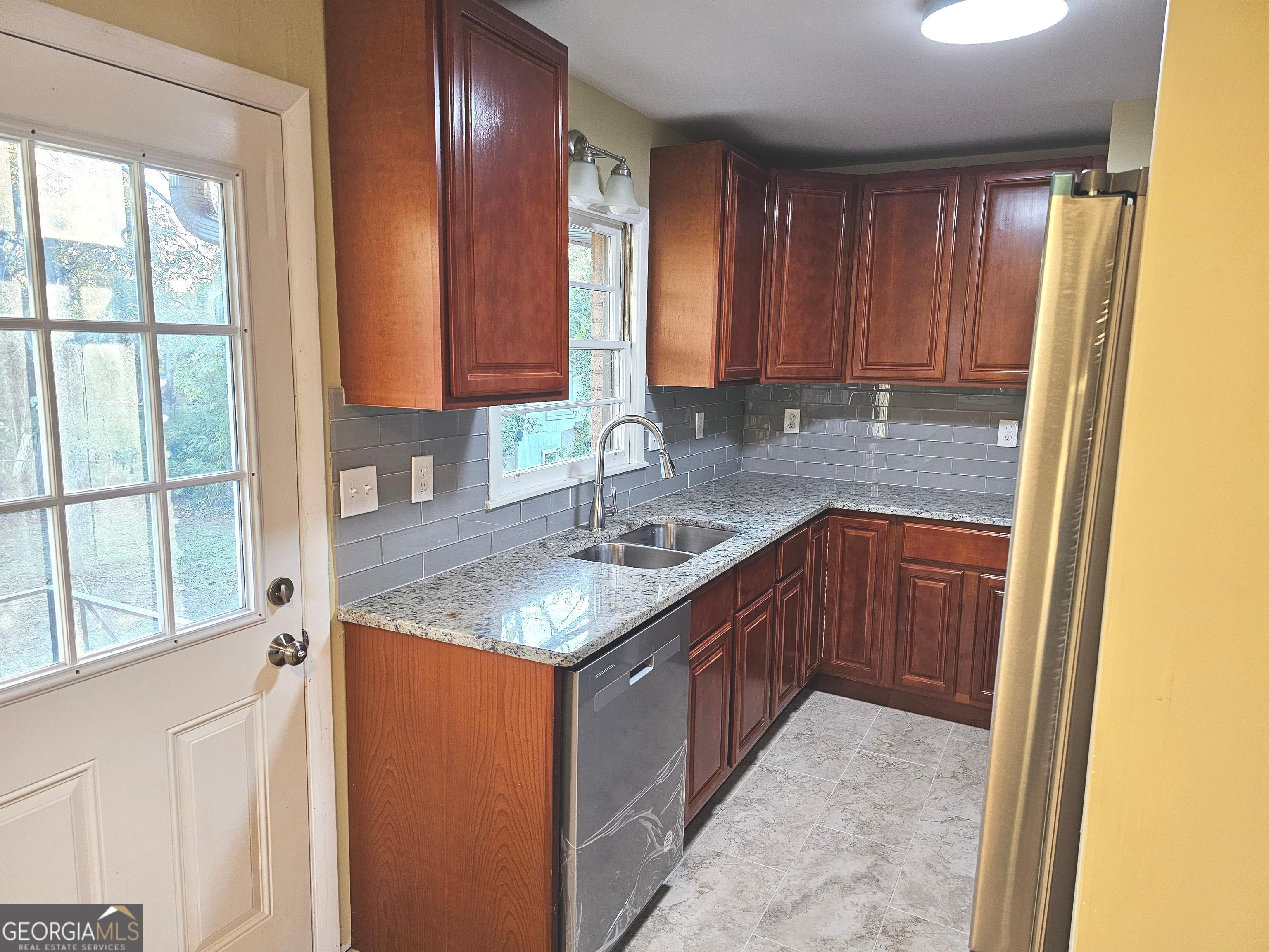 655 Shellnut Drive Forest Park, GA 30297 - Photo 10 of 31 a kitchen with a sink a counter top space and cabinets
