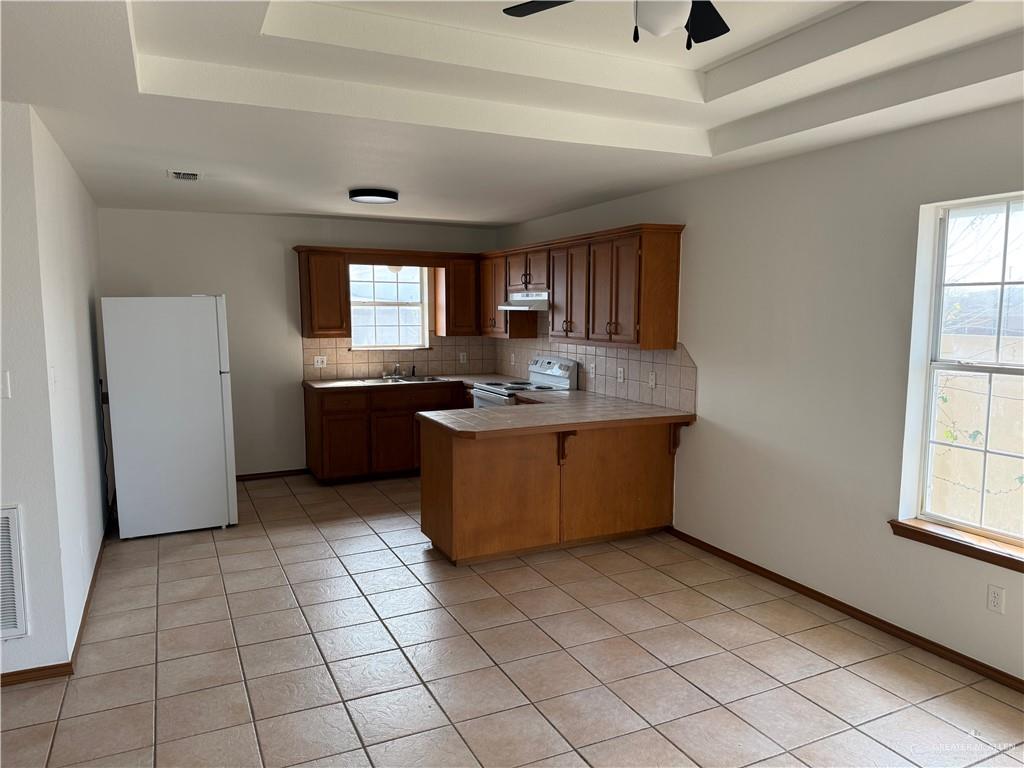 3803 Clavel Street Mission, TX 78572 - Photo 7 of 10 a kitchen with stainless steel appliances granite countertop a sink counter space cabinets and a window