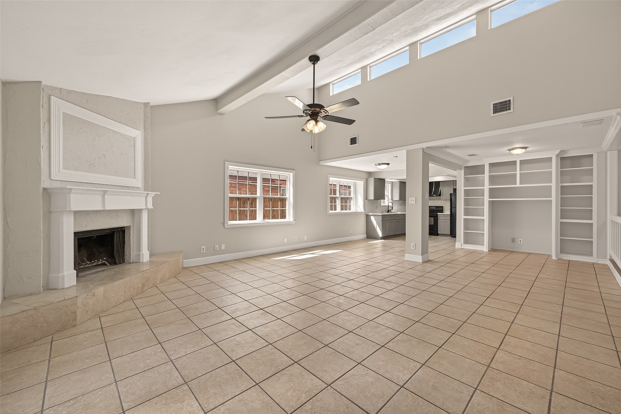 9503 Turtle Log Trail Houston, TX 77064 - Photo 12 of 41 a view of an empty room with a fireplace and a window