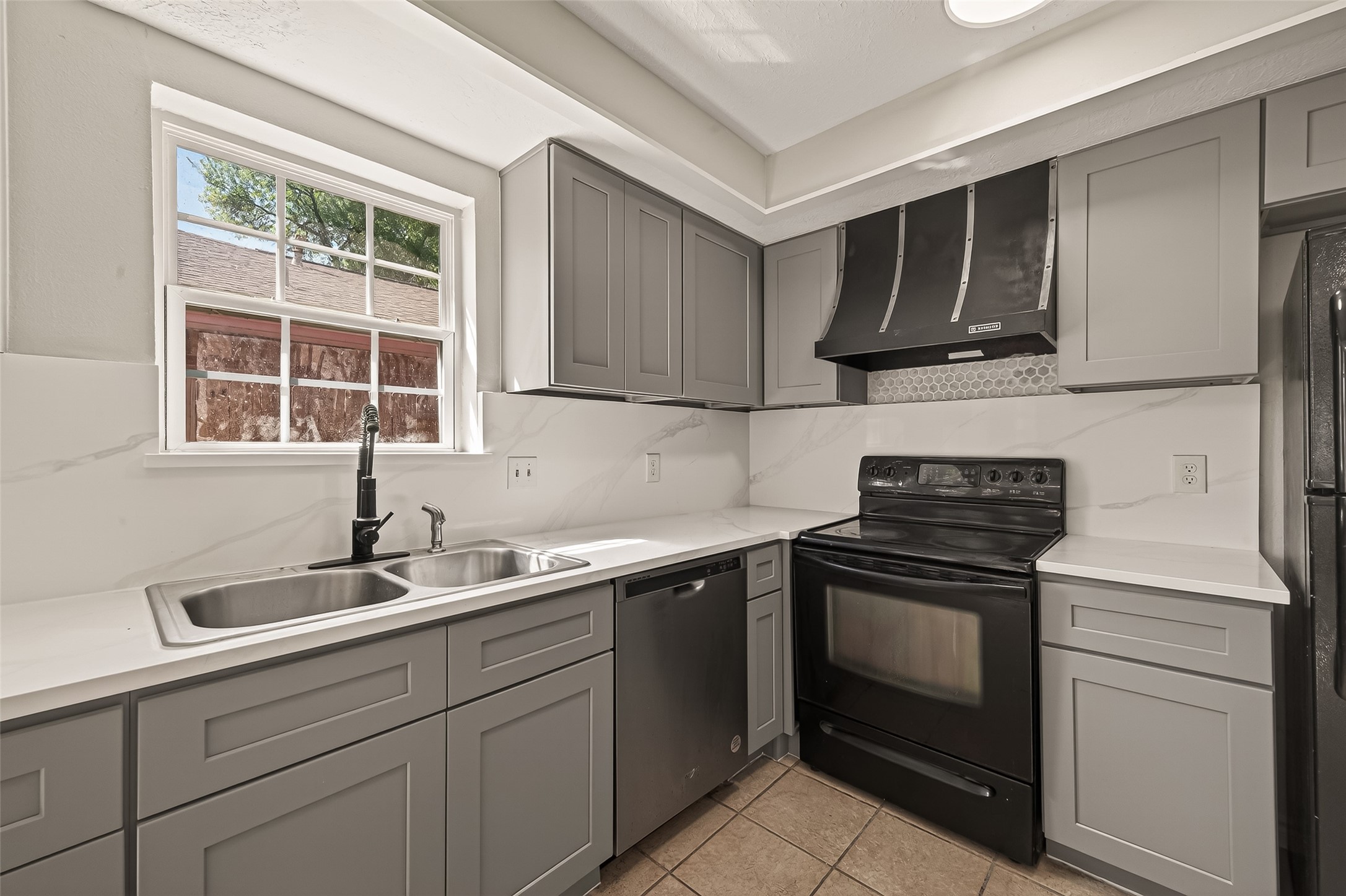 9503 Turtle Log Trail Houston, TX 77064 - Photo 19 of 41 a kitchen with stainless steel appliances a stove sink and cabinets