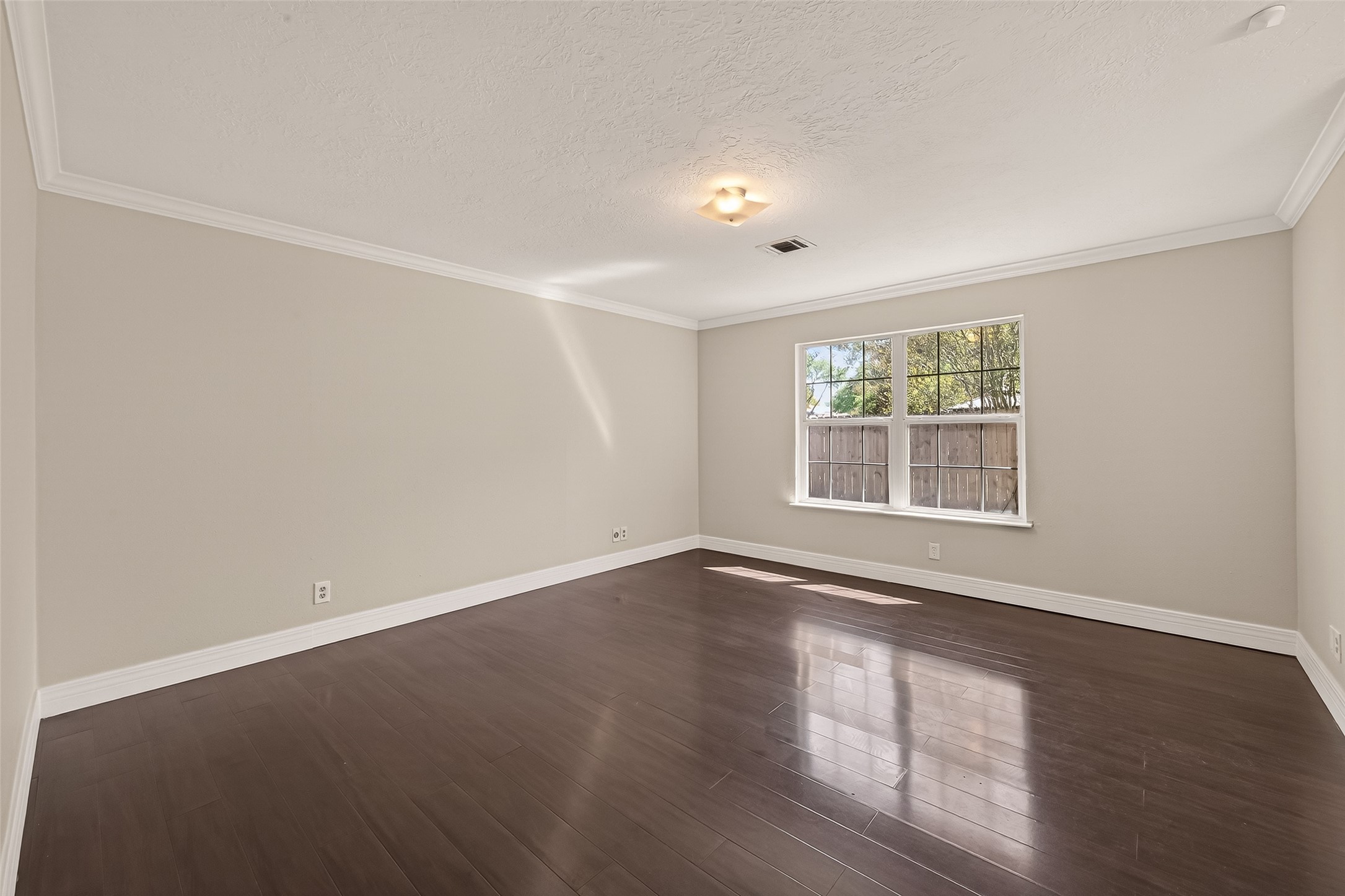 9503 Turtle Log Trail Houston, TX 77064 - Photo 30 of 41 an empty room with wooden floor and windows