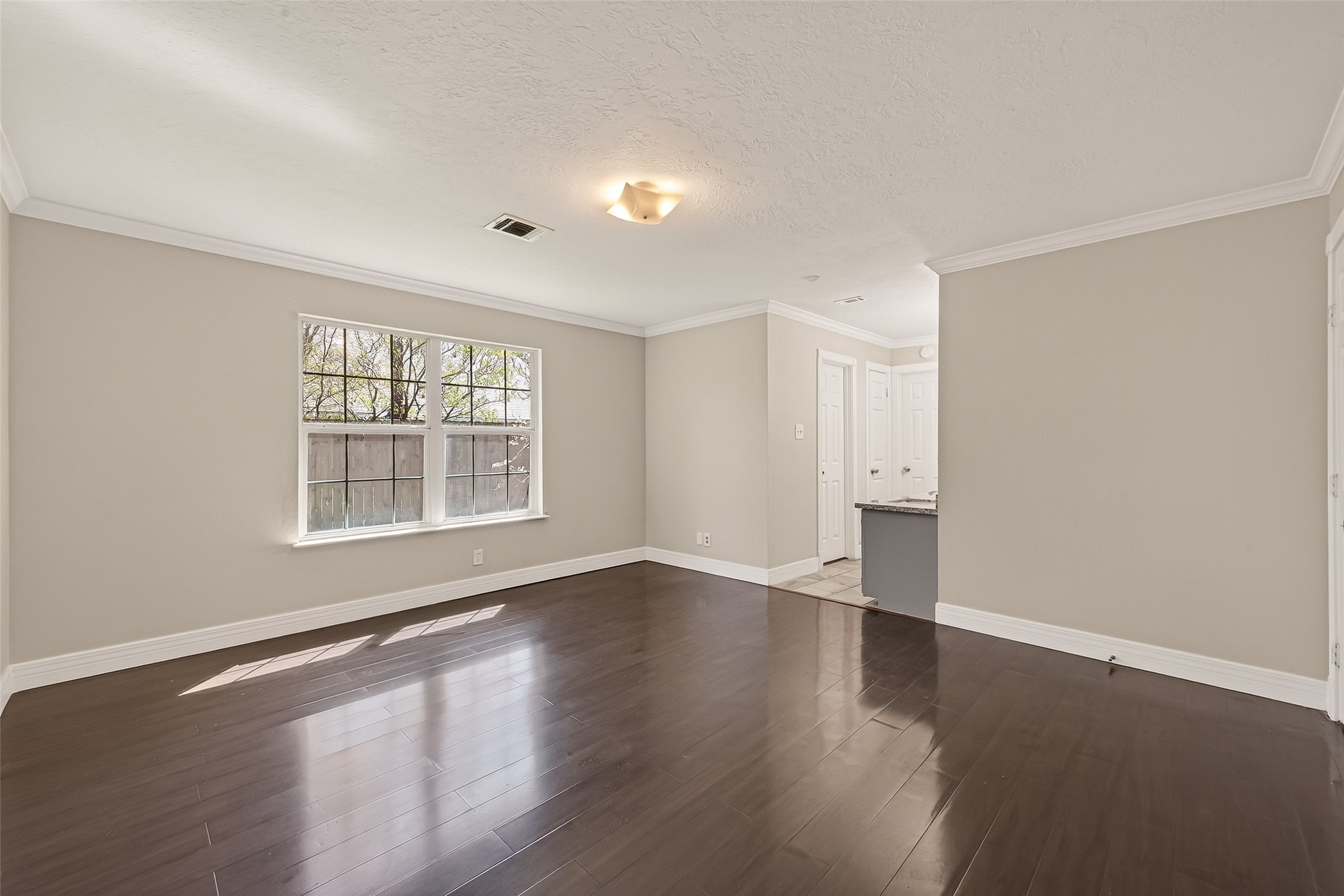 9503 Turtle Log Trail Houston, TX 77064 - Photo 31 of 41 a view of an empty room with wooden floor and a window