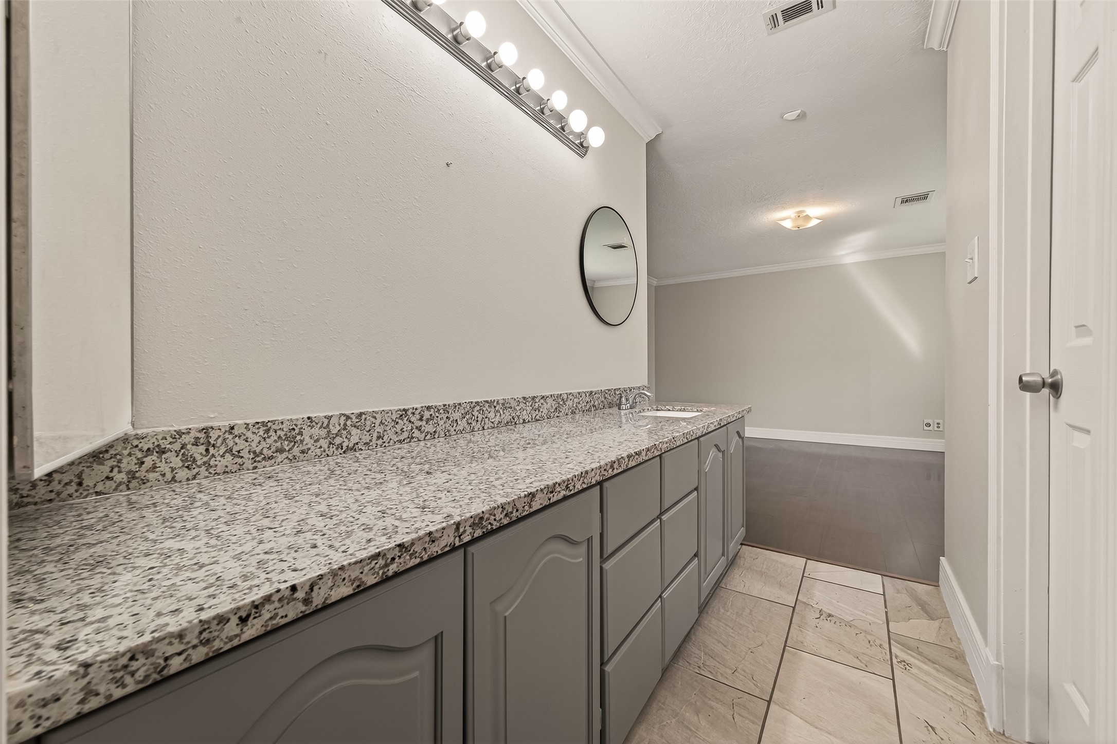 9503 Turtle Log Trail Houston, TX 77064 - Photo 34 of 41 a bathroom with a granite countertop sink and a mirror