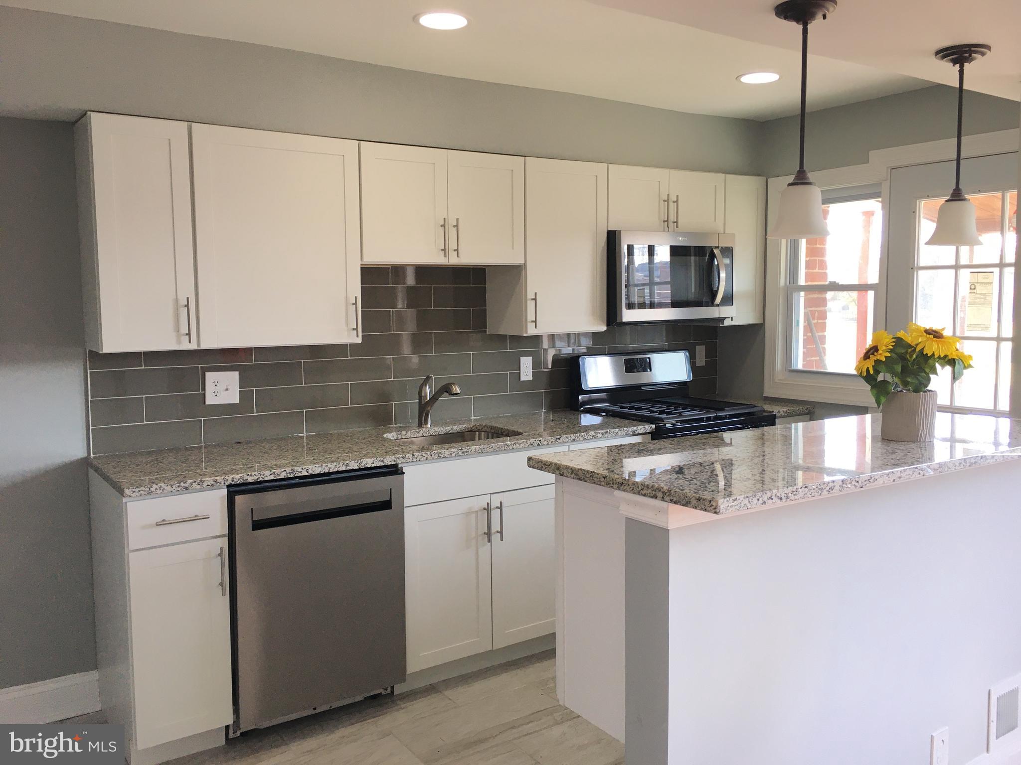 7441 Edsworth Road Baltimore, MD 21222 - Photo 11 of 37 a kitchen with stainless steel appliances granite countertop a sink a stove and cabinets