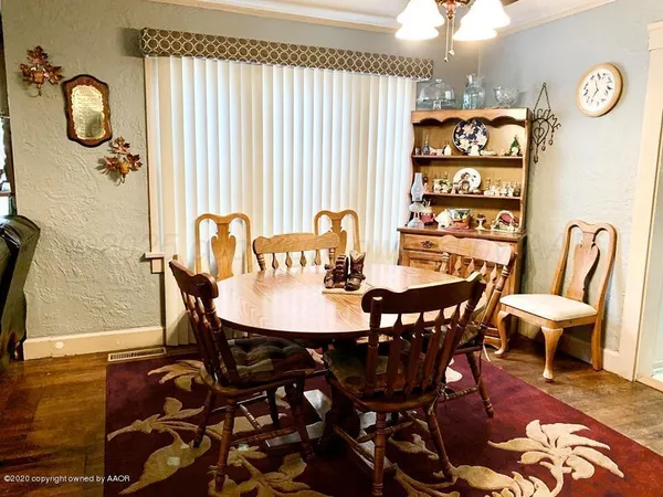 a view of a dining room with furniture and chandelier