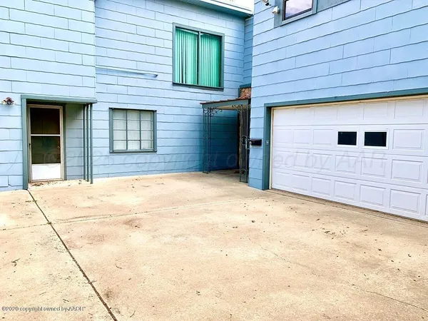 a view of yellow house with a outdoor space