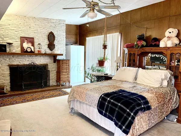 a bedroom with a bed and a fireplace