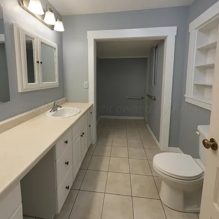 a bathroom with a sink a toilet and mirror