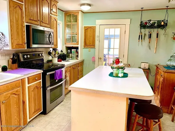a kitchen with a stove a sink and a refrigerator