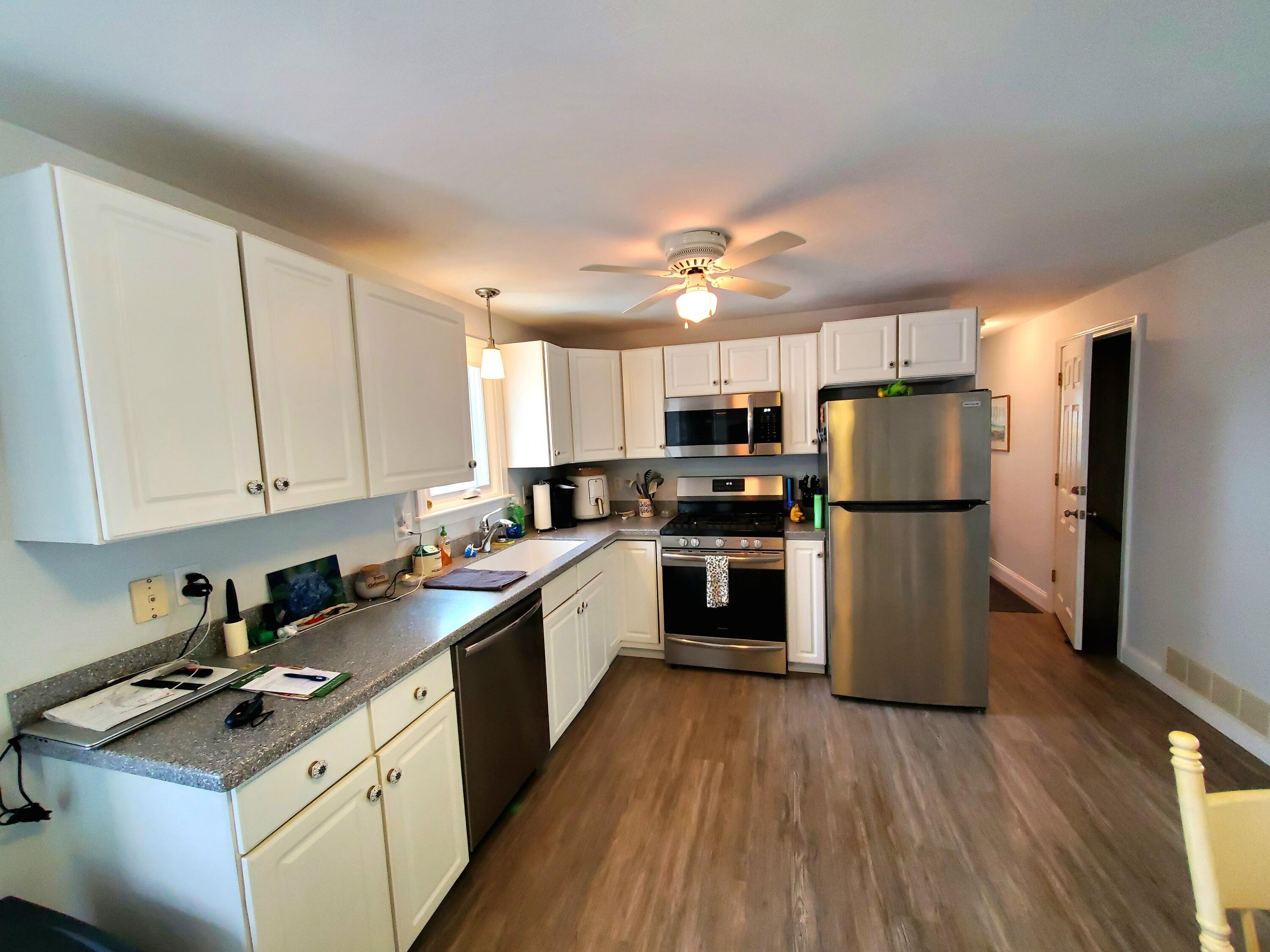 52 Thayer Road Dennis, MA 02660 - Photo 6 of 19 a kitchen with a refrigerator a stove top oven a sink and cabinets