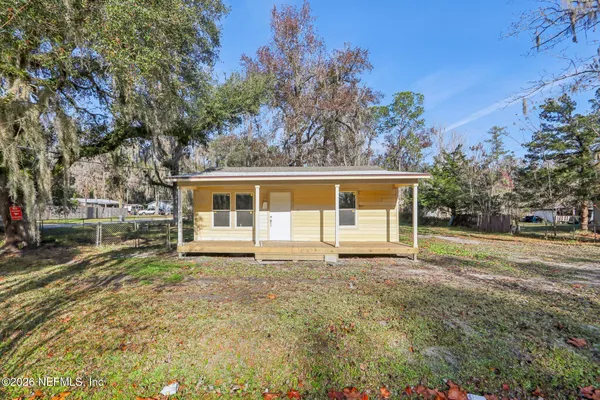 a house that has a big yard in front of it