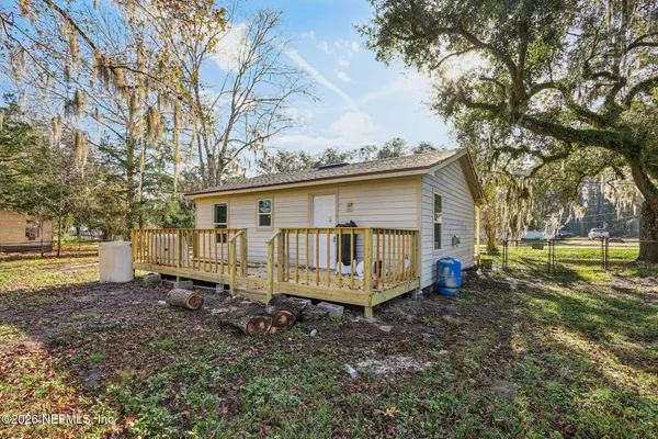 a backyard of a house with barbeque oven table and chairs