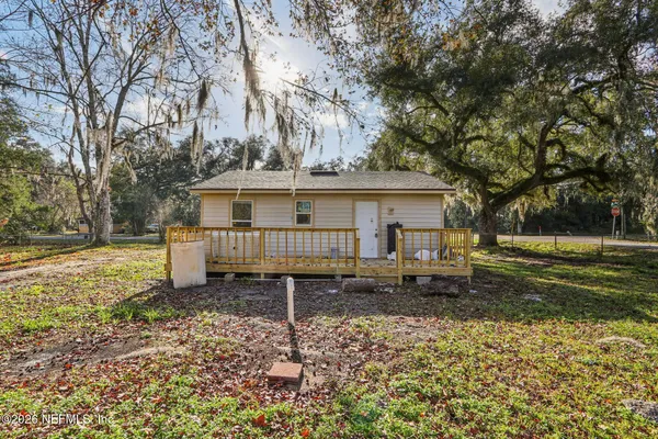 a backyard of a house with barbeque oven table and chairs