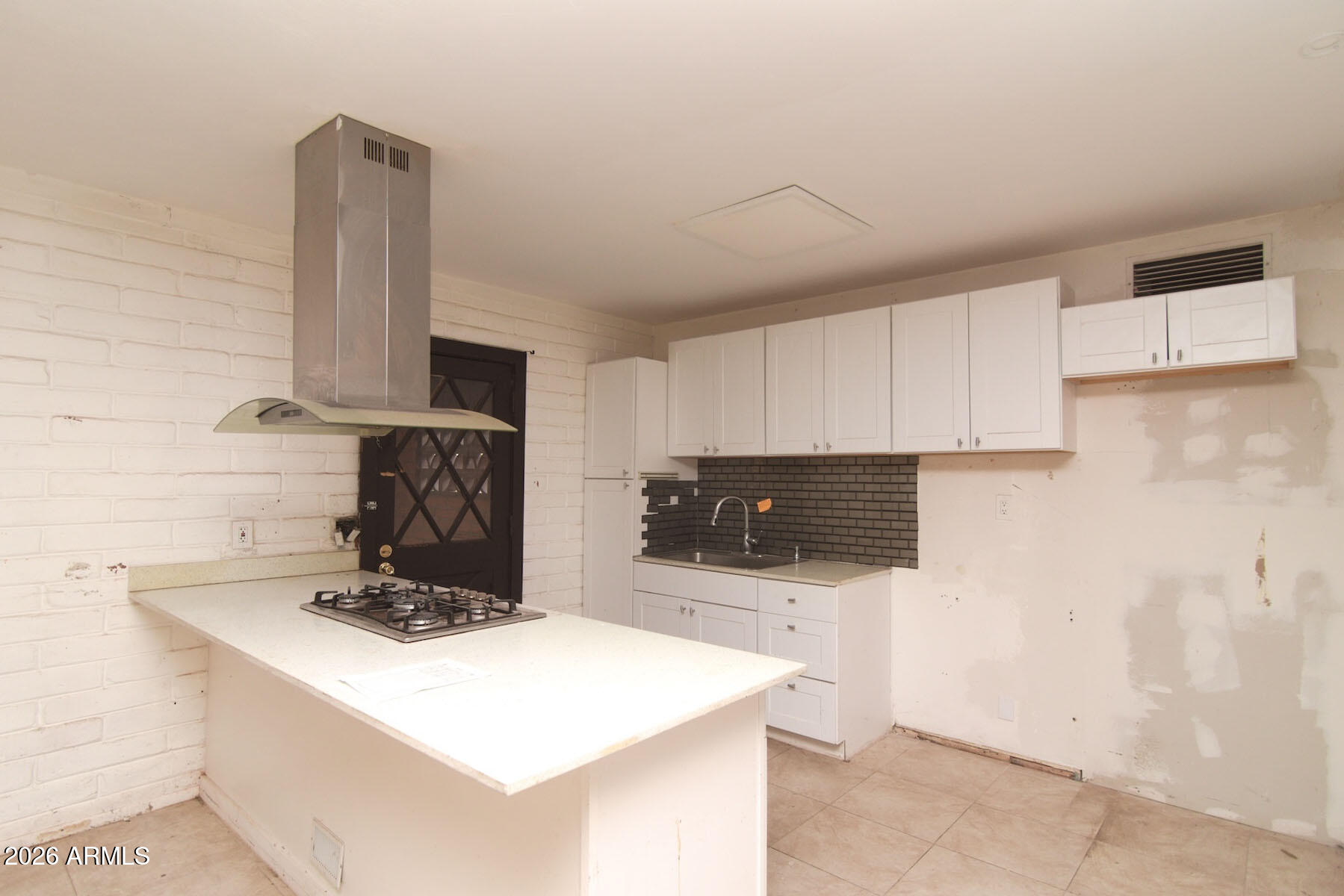 1176 North Royal Road Nogales, AZ 85621 - Photo 4 of 10 a kitchen with stainless steel appliances a stove a microwave a sink and cabinets