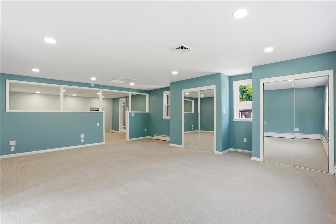 6271 Batman Road Zionsville, PA 18092 - Photo 50 of 100 A spacious room features plush carpet and ample recessed lighting for comfortable living.