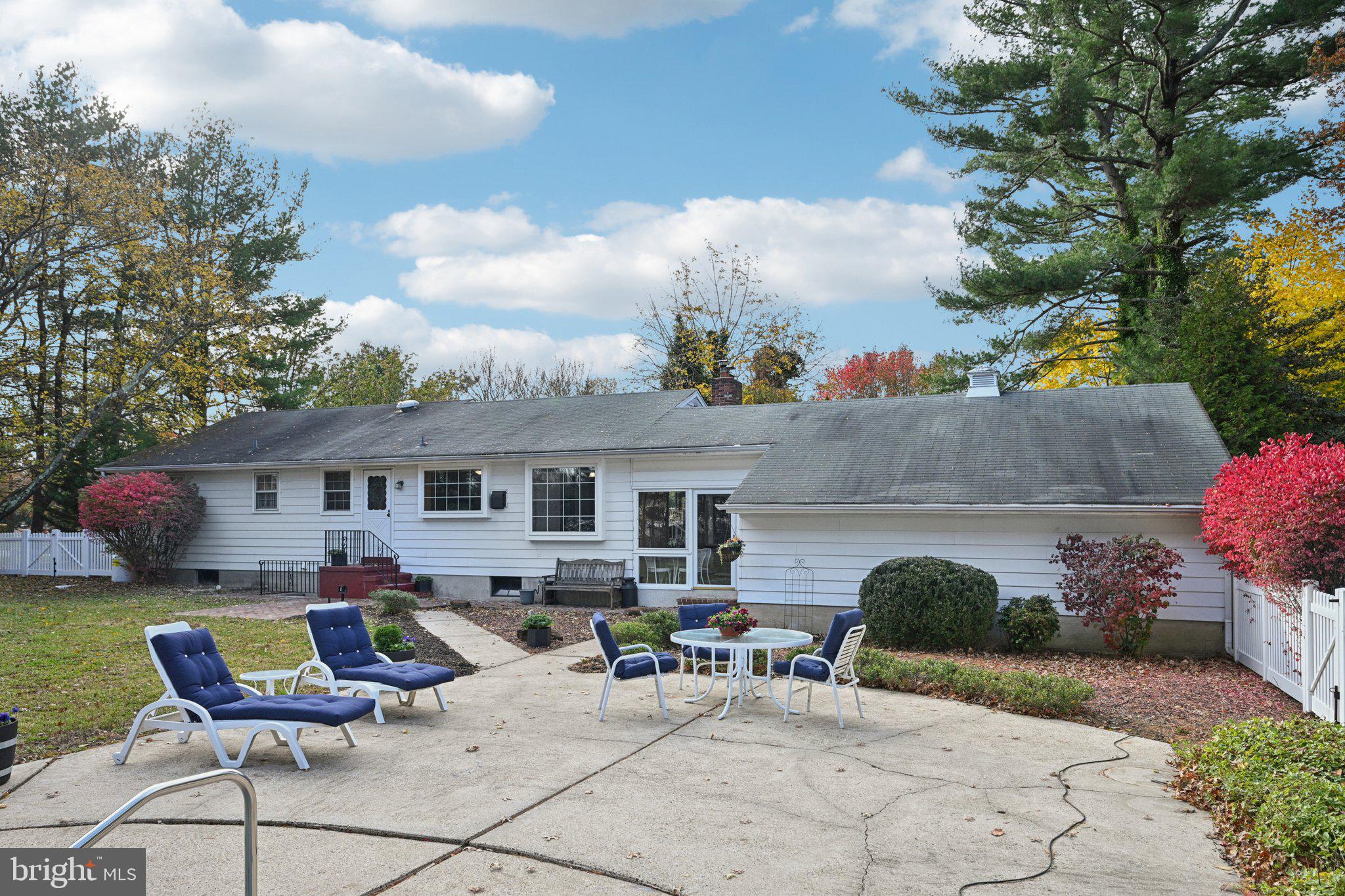 12 Jennings Road Medford, NJ 08055 - Photo 34 of 48 a view of a patio with couches table and chairs under an umbrella