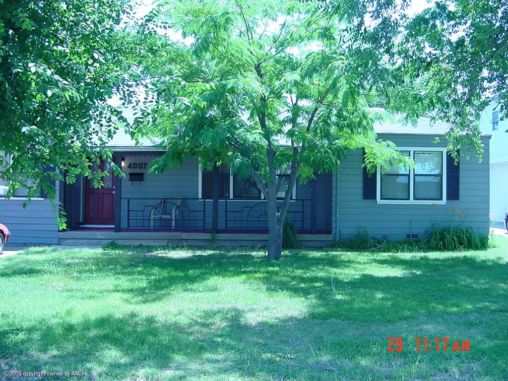 4007 Cline Road Amarillo, TX 79110 - Photo 1 of 11 a backyard of a house with plants and large trees