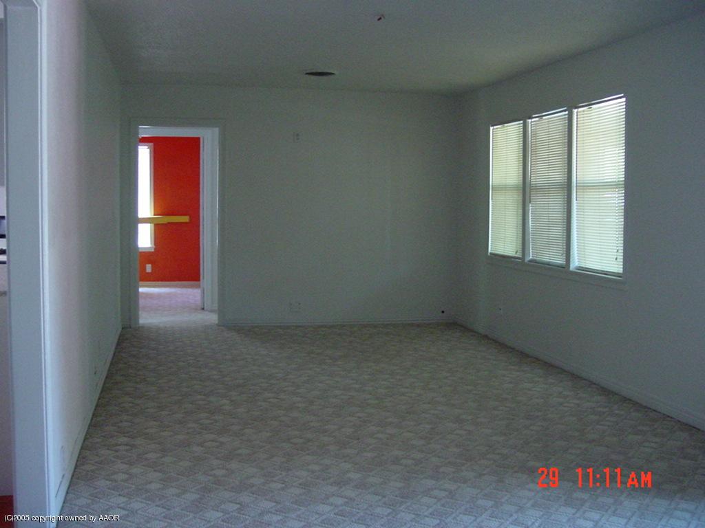 4007 Cline Road Amarillo, TX 79110 - Photo 2 of 11 an empty room with a window