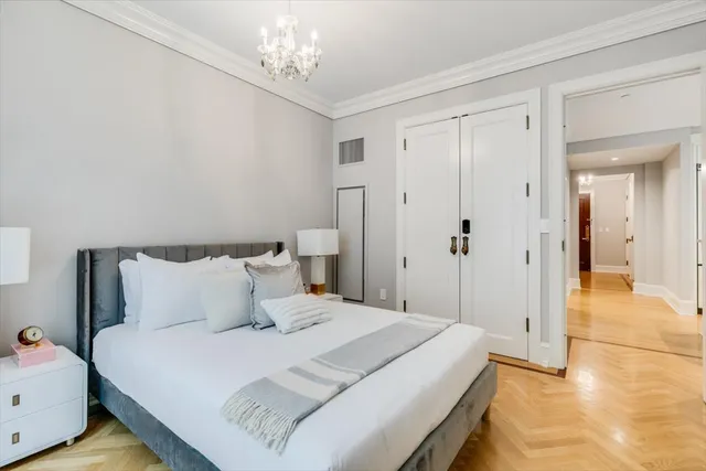 a bedroom with a bed and a potted plant