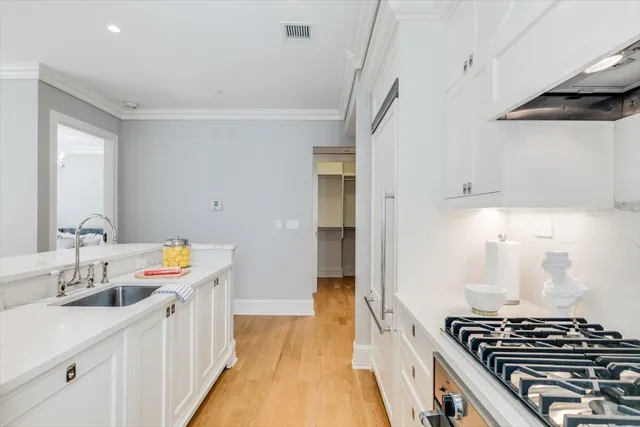 a kitchen that has a sink cabinets and a window