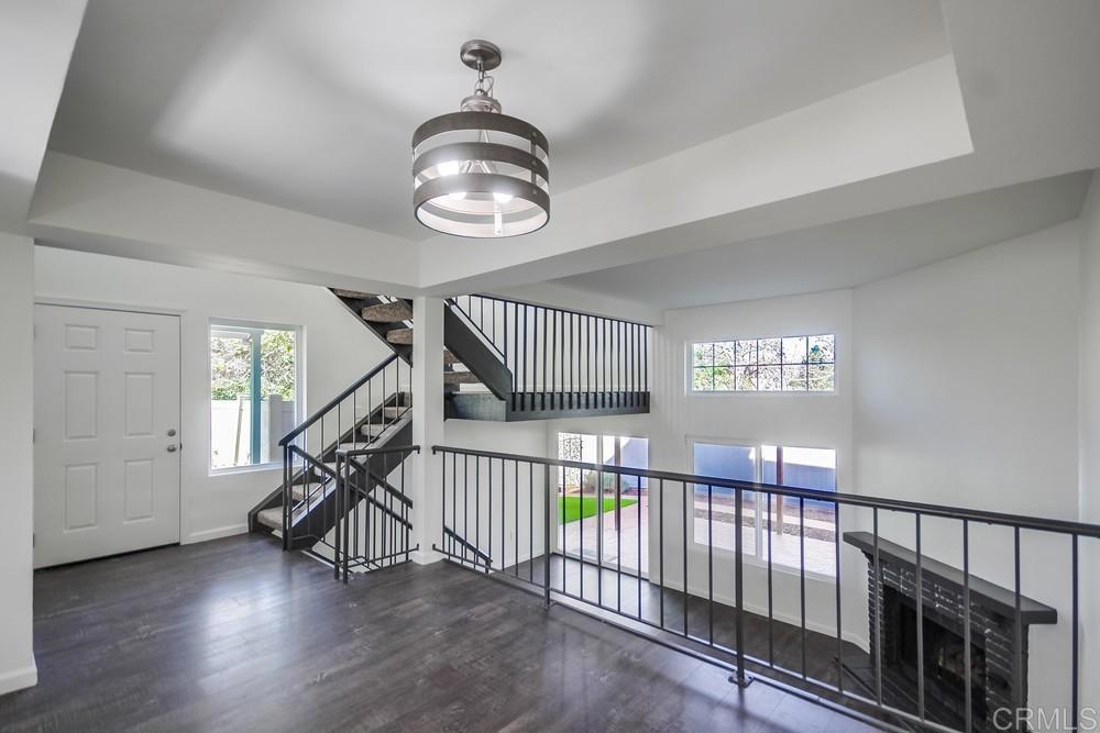 8702 Spring Canyon Drive Spring Valley, CA 91977 - Photo 4 of 22 a view of staircase with wooden floor and windows