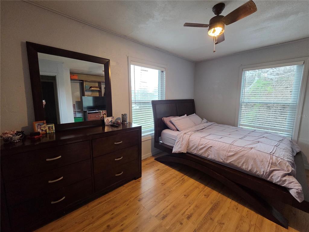 124 East F Street Frostproof, FL 33843 - Photo 15 of 37 a bedroom with a bed and a dresser