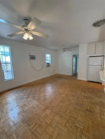 a view of a livingroom with a ceiling fan and window