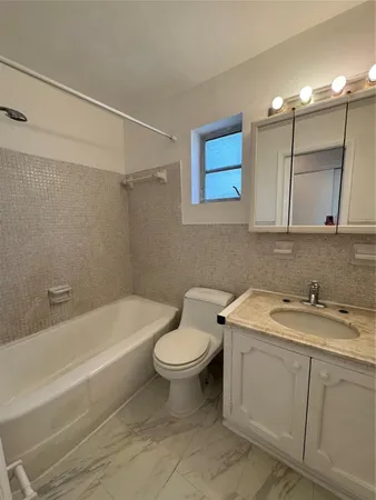 a bathroom with a sink a toilet and bathtub