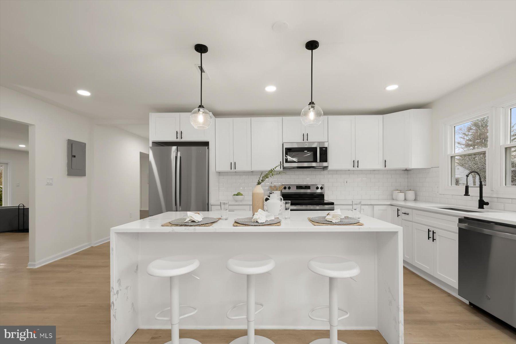 2025 Greengage Road Windsor Mill, MD 21244 - Photo 11 of 28 a kitchen with kitchen island granite countertop a sink a center island and cabinets