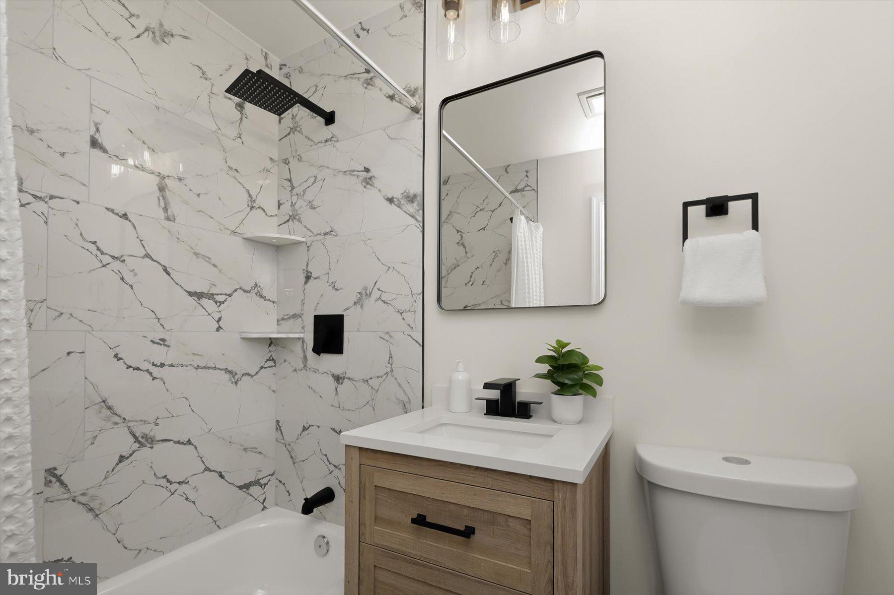 2025 Greengage Road Windsor Mill, MD 21244 - Photo 16 of 28 a bathroom with a sink toilet and vanity