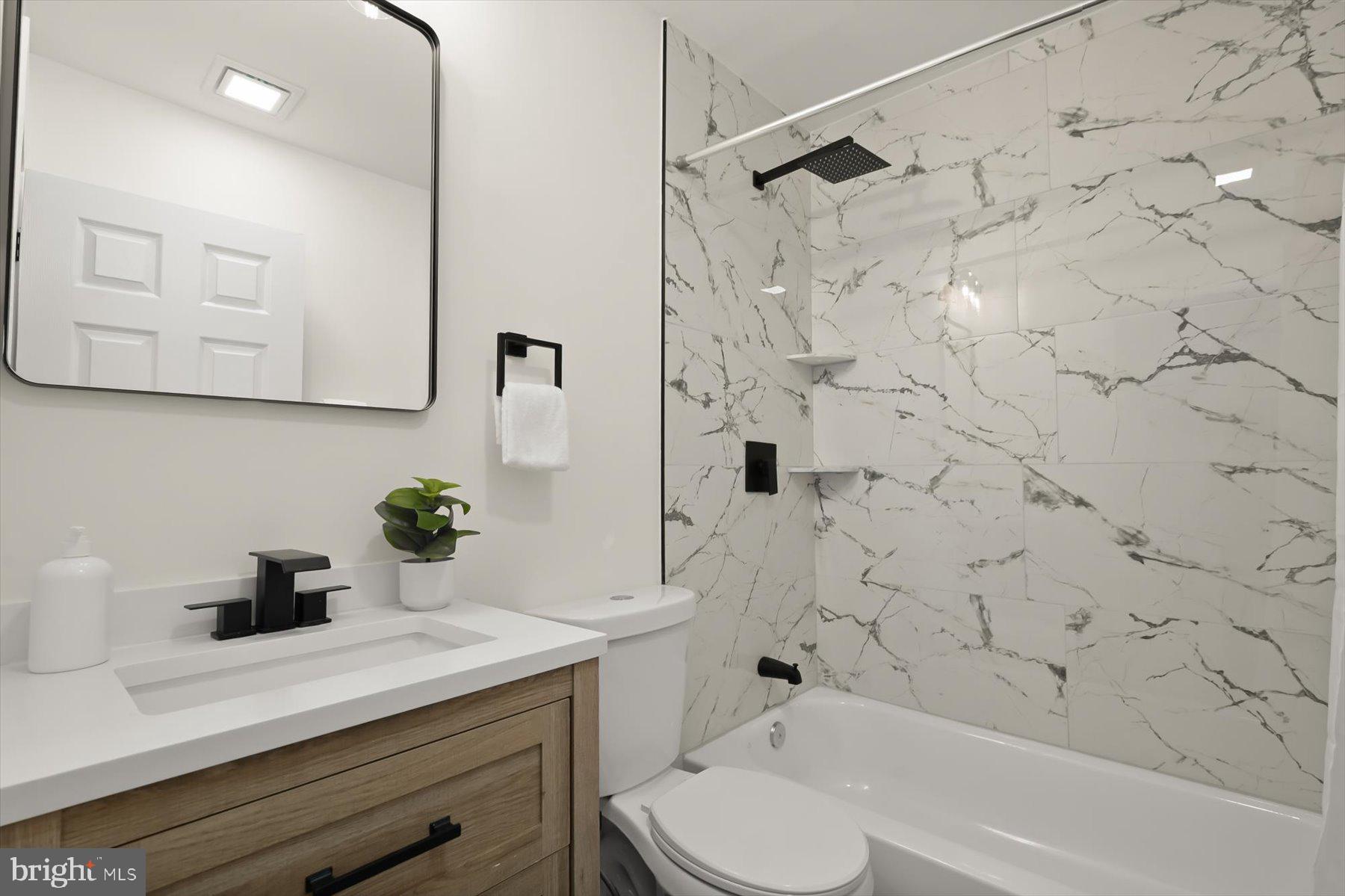2025 Greengage Road Windsor Mill, MD 21244 - Photo 19 of 28 a bathroom with a sink a toilet and shower