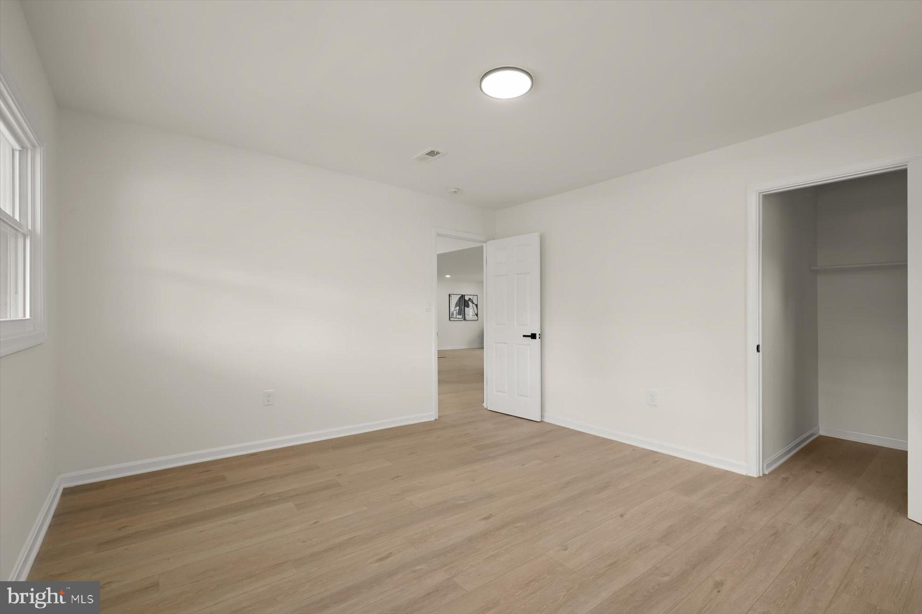 2025 Greengage Road Windsor Mill, MD 21244 - Photo 23 of 28 an empty room with wooden floor and windows
