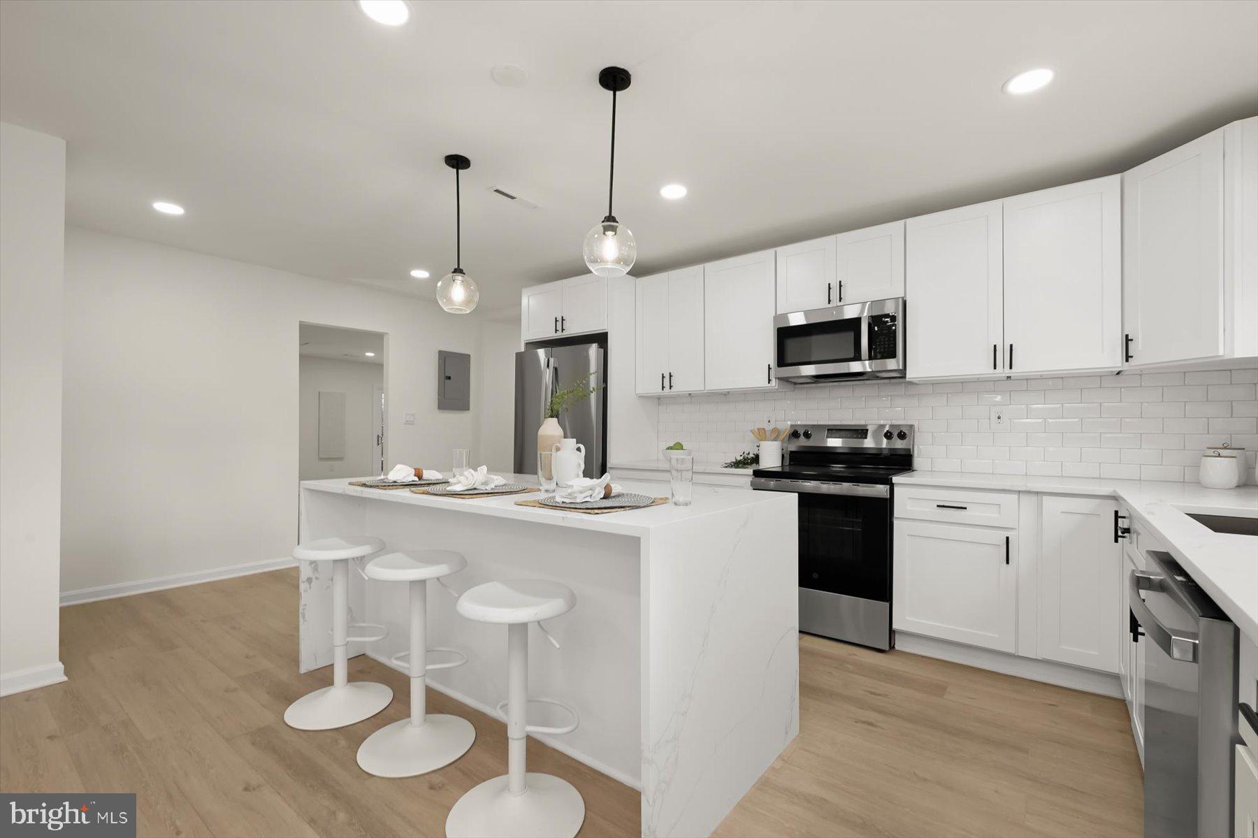 2025 Greengage Road Windsor Mill, MD 21244 - Photo 6 of 28 a kitchen with kitchen island granite countertop a sink cabinets and stainless steel appliances